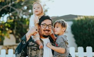 Parent holding two kids